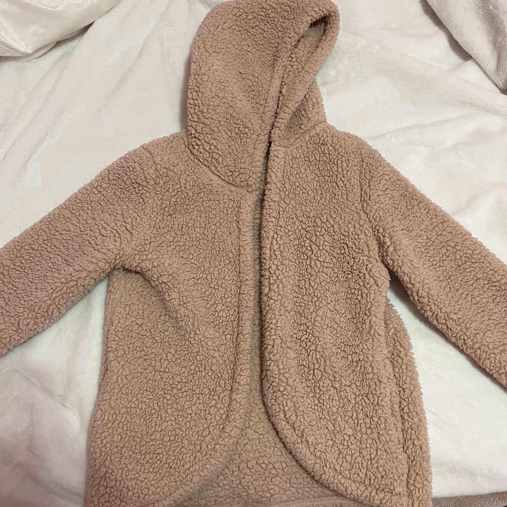 Pink fuzzy throw over sweater